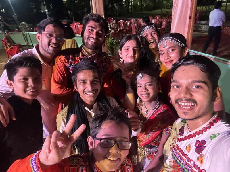 A big group selfie of smiling young residents at the garba